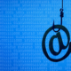 Hook and email icon symbolize phishing emails.