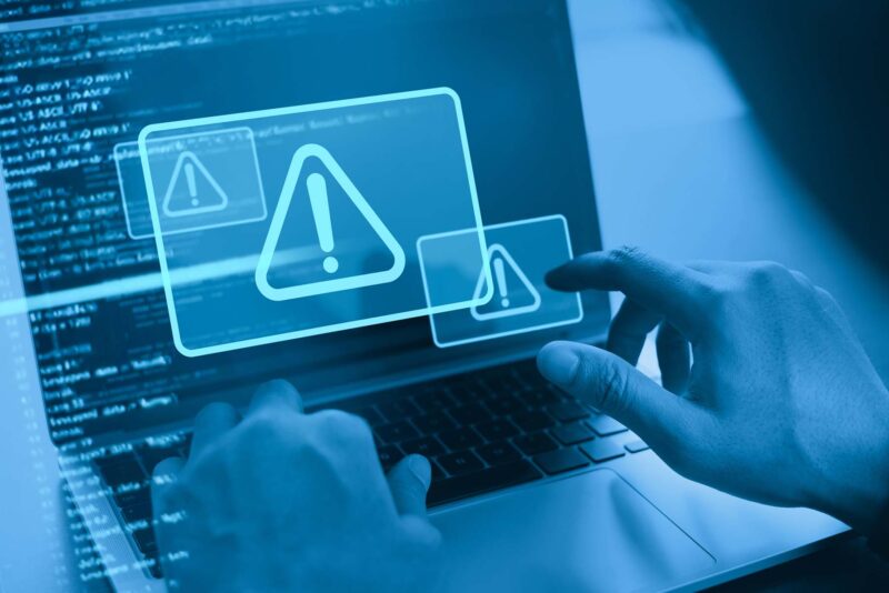 laptop with system hacked alert